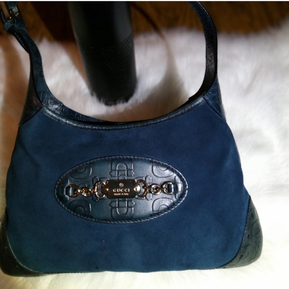 This is a blue Gucci suede shoulder bag.